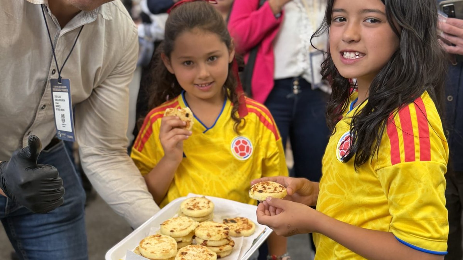 Sharing pandebono with visitors at the trade fair